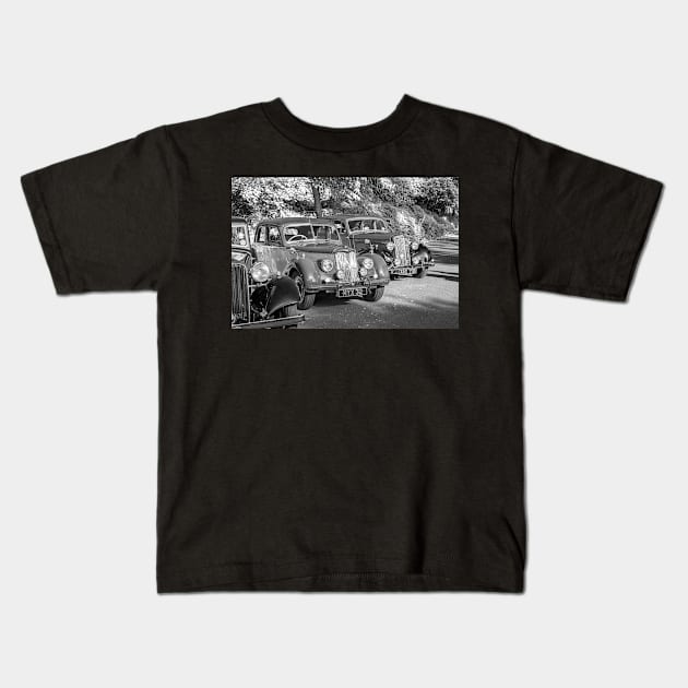 Row of vintage cars on display Kids T-Shirt by yackers1